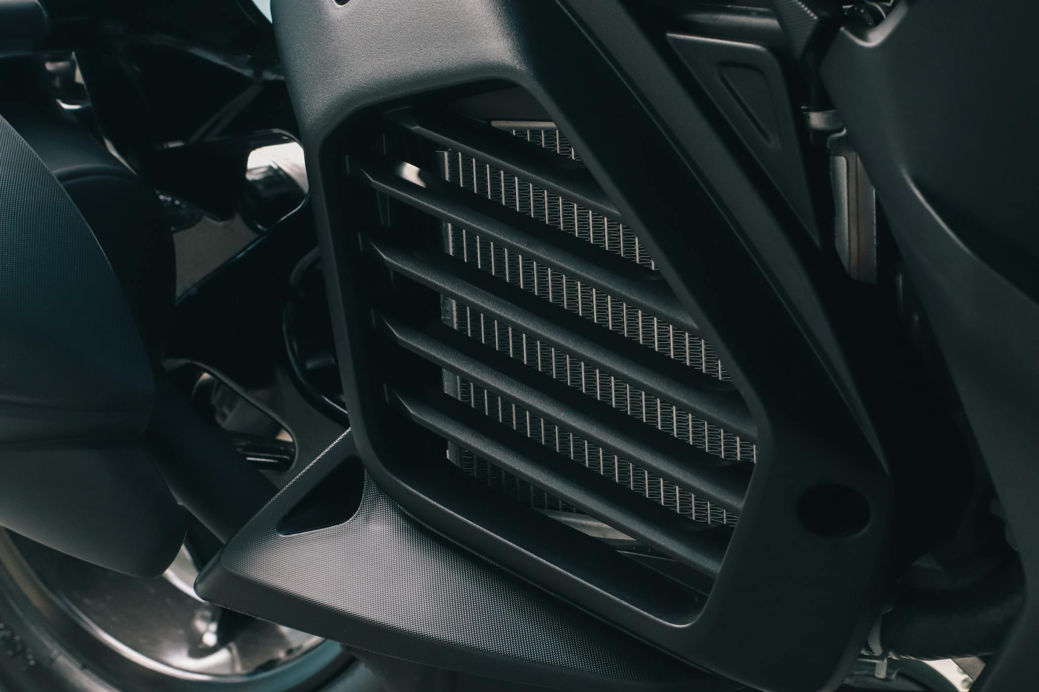 Detailed close-up of a motorcycle engine's cooling fins and components.