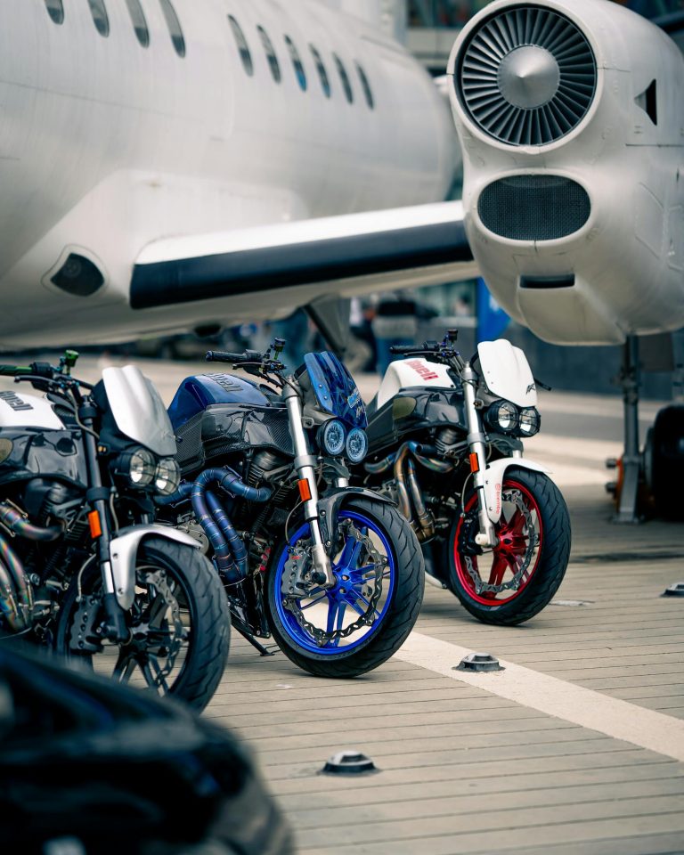 Motorcycles in front of a plane